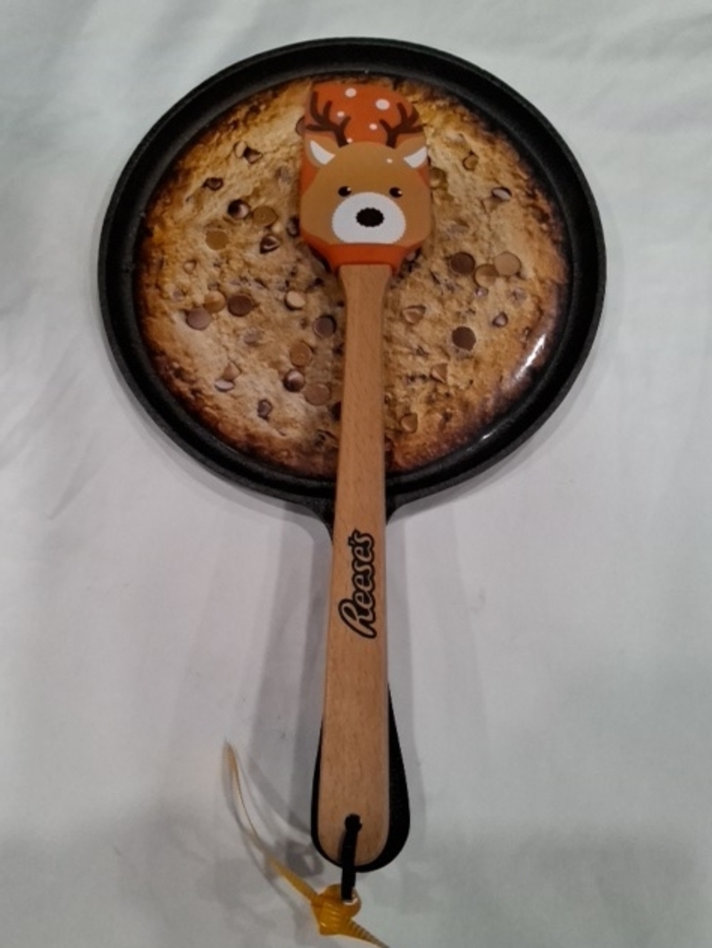Orange Reindeer Silicone Spatula With Cast Iron Pan.